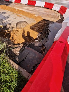 Unexpected road damage creates a hazardous area