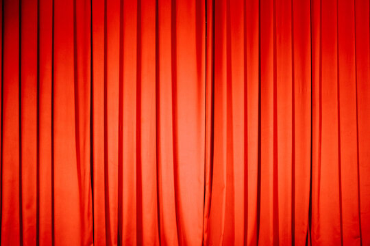 Elegant red stage curtain covering a performance venue