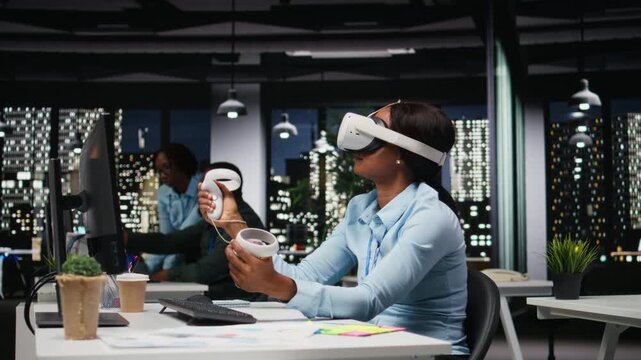 African american woman employs AI gadget with virtual reality in dark office, doing overtime at the corporation workspace with VR glasses to ensure fact checking and analyze projections. Camera A.