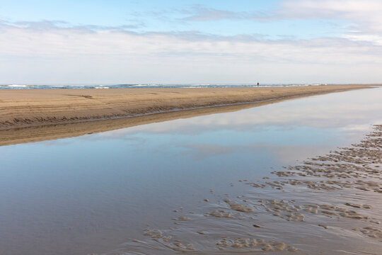 Tide pools and vast beach at dusk