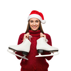 Smiling young Caucasian woman in a red Santa hat and warm knitted sweater holding white ice skates, ready for winter holiday fun and festive activities.