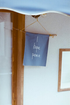 Hanging Sign with Peace Message Outside Building