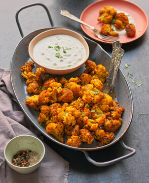 Spicy cauliflower bites with garlic yogurt sauce.