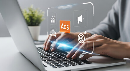 Person types on a laptop with a digital interface overlay showing icons related to advertising, including charts, global reach, a megaphone, and a target.