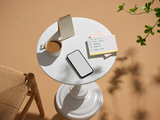 Workspace setup featuring a phone, to-do list, and a cup of coffee