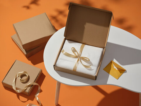 A beautifully wrapped gift in an open box with a ribbon
