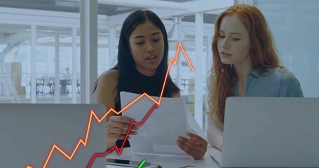 Two office professionals reviewing printed report in modern office, with laptops and data overlay