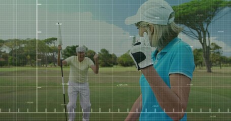 Wearing cap and glove, golfer on golf green, looking back at man pumping flagstick, copy space