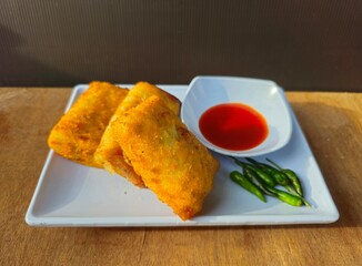 fish and chipsRisole,Rissoles,Risol is snack fiiled with vegetables,smoked beef,sausage,cheese,mayonnaise sauce,wrapped in risol skin and bread crumbs served with green cayenne pepper and chili sauce 