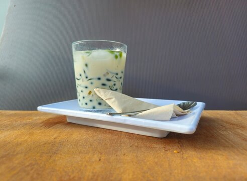 glass of milkCendol is an iced sweet dessert contains pandan flavored green rice flour jelly,coconut milk and pandan sugar,additional toppings are dinced jackfruit,red bean,durian.Javanese called Dawe