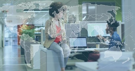 Transparent world map overlay fading in team tapping tablet and typing laptop for business analysis - Powered by Adobe