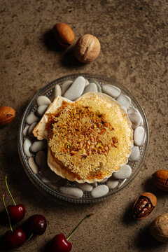 Baked scallop with cheese and chopped nuts on shell