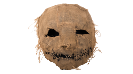 Handcrafted burlap mask with hollow black eye sockets and stitched mouth on transparent background