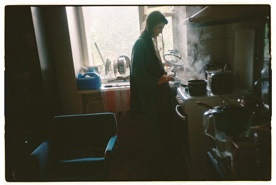 Cooking in a cozy kitchen with steam rising from pots