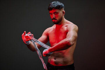 Boxer preparing for training session with hand wraps