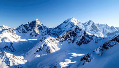 Dramatic Mountain Peaks Covered in Snow Under Bright Blue Sky Mountain Range in Winter Landscape Wide Angle View Scenic Outdoors