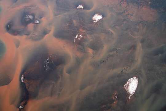 Abstract Aerial View of Glacial Rivers and Sediment Patterns in Icelan