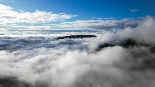 Aerial View of Mountains Covered in Clouds
