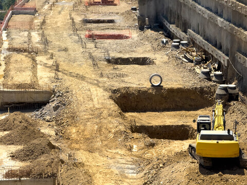 Excavation Site With Heavy Equipment and Soil Preparation in Progress