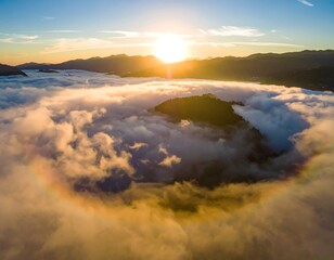 Sunrise through clouds, mountain valley