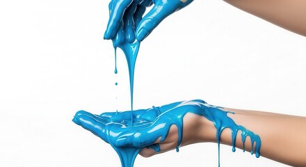 Bright blue liquid paint dripping from one hand into another, creative flow