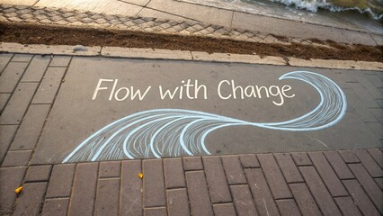Inspirational message on sidewalk encouraging growth and transformation through change with artistic wave design