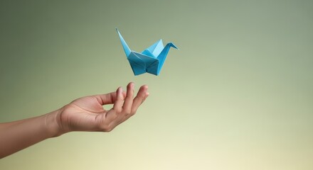 Origami crane in hand offering hope peace healing concept for business personal growth health support and creativity
