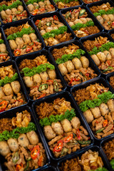 Indonesian catering meal boxes with traditional side dishes and vegetables