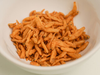Crunchy fried anchovy piled on white background