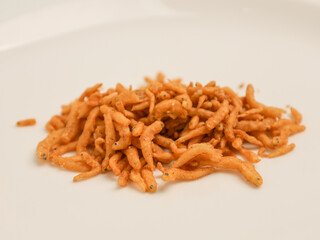 Crunchy fried anchovy piled on white background