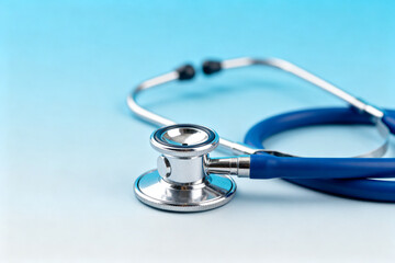 Blue stethoscope on light blue background