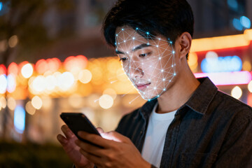 Young man using phone with face recognition