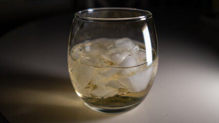 White Wine with Ice in a Stemless Glass at Night
