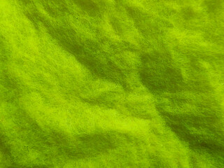 Wrinkled and Textured Green Non-Woven Fabric Close-Up with Soft Fuzz Fibers and Shadow Folds
