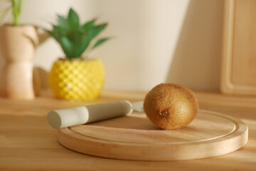 Fresh kiwi fruit on a wooden cutting board in kitchen