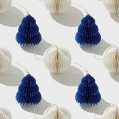 Seamless Minimal pattern of blue white paper Christmas ornaments shaped Christmas fir trees and balls on white, stylish holidays layout. Festive aesthetic print. Merry Christmas happy New Year concept