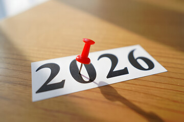 2026 Calendar Planning with Red Pushpin on Corkboard in Office Setting