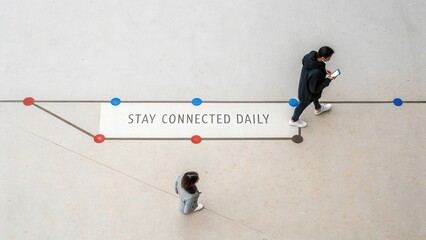 People Walking on Floor with Motivational Quote Emphasizing Connection and Communication in Modern Environment