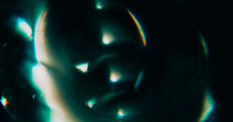 Blur optical glow. Radiant light. Green color glare shadow glimmer crystal rainbow reflection on warm illuminated art dark black abstraction.