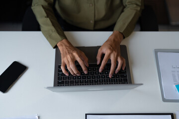 Closeup of Businessman Hands Typing on Laptop in Office.