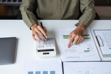 Male Professional Using Calculator for Business Budget Analysis.
