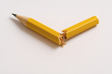 Broken Yellow Pencil on White Background
