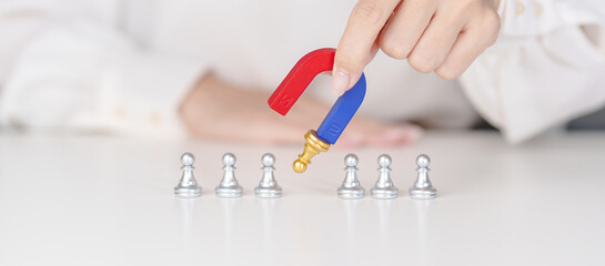 Hand use magnet pulling to golden chess pawn pieces or leader businessman stand out of crowd people...