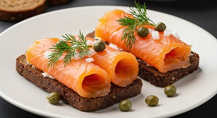 Smoked salmon appetizers with capers and dill on rye bread plate