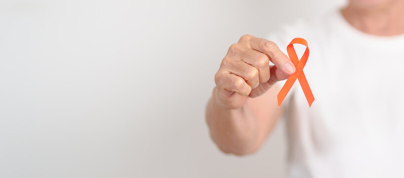 Elderly with Orange Ribbon for September Leukemia, March Kidney cancer day, Multiple Sclerosis, November Complex Regional Pain Syndrome, CRPS, COPD, Chronic Obstructive Pulmonary disease concepts