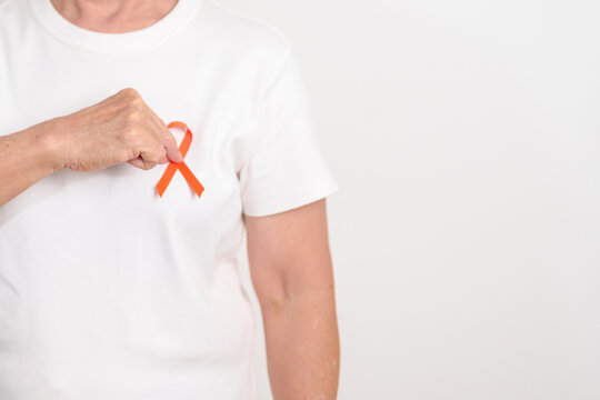 Elderly with Orange Ribbon for September Leukemia, March Kidney cancer day, Multiple Sclerosis, November Complex Regional Pain Syndrome, CRPS, COPD, Chronic Obstructive Pulmonary disease concepts - Powered by Adobe