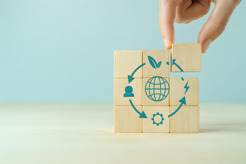 Circular economy concept with wooden cubes showing recycle, reuse, waste, manufacturing, consumer resources, and LCA life cycle assessment, symbolizing sustainability