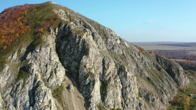 An aerial drone shot captures the majestic Shihan Yuraktau mountain in the South Ural region of Russia. This unique geological formation, a remnant of a massive barrier reef from 280 300 million years