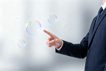 Man in suit pointing at floating bubbles