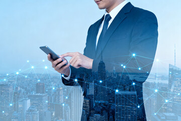 Businessman using smartphone with network overlay